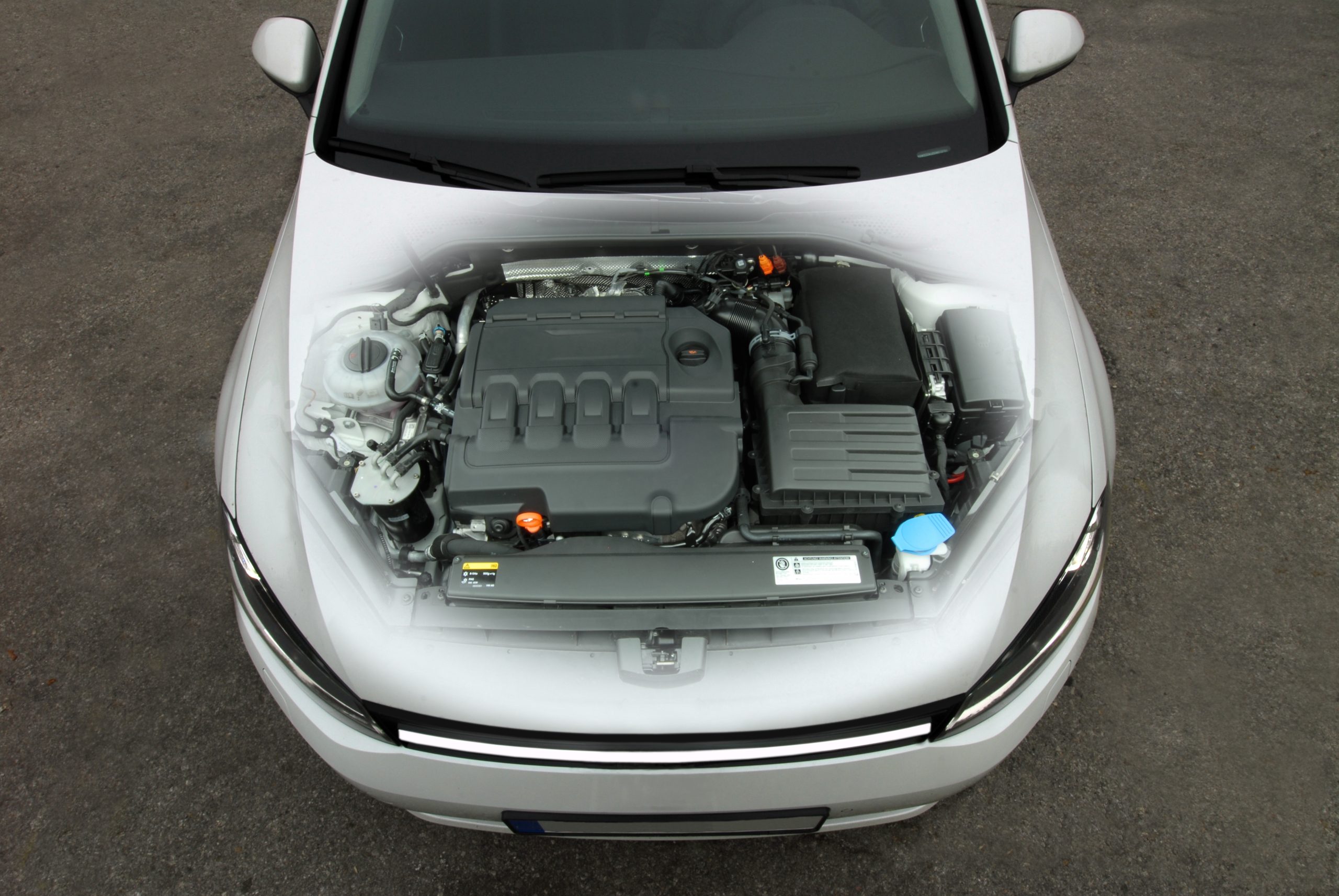 Overhead top view of 3D rendered car with transparent hood showing contents of engine compartment